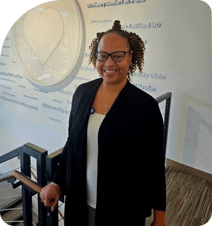 headshot of Rashidah Haqq standing in front of the family care center sign in Pflugerville Texas.