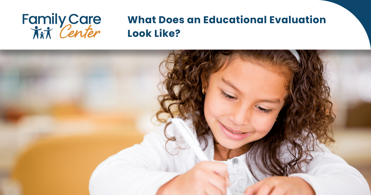 A young girl with curly brown hair completes an educational evaluation